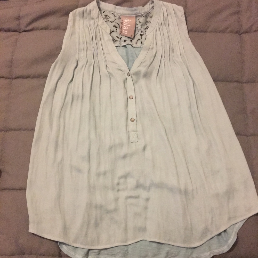 Flowing Sleeveless Dolan Top with Lace Accents.